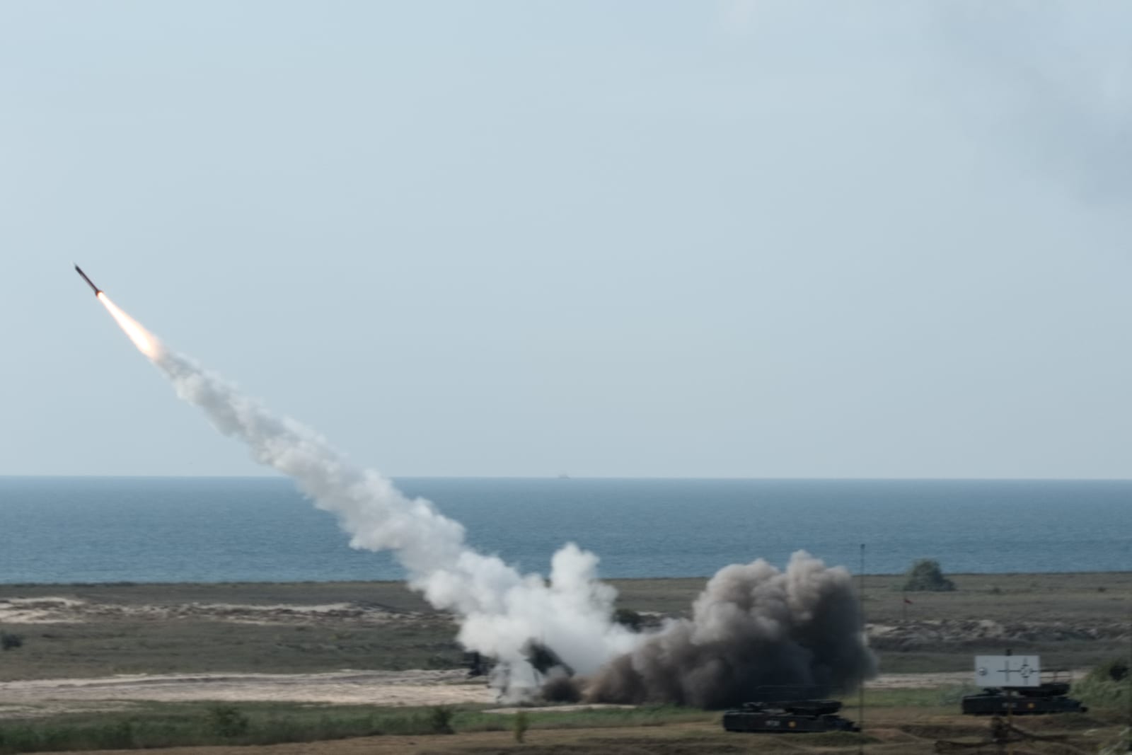 A Patriot missile launches from a battery during a live-fire exercise near Capu Midia, Romania, with the Black Sea in the background
