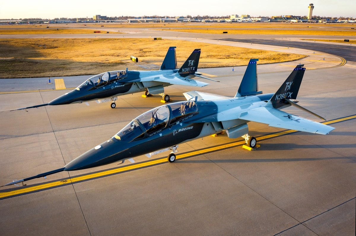 Two Boeing T-7A Red Hawk trainer jets parked on a flight-line ramp