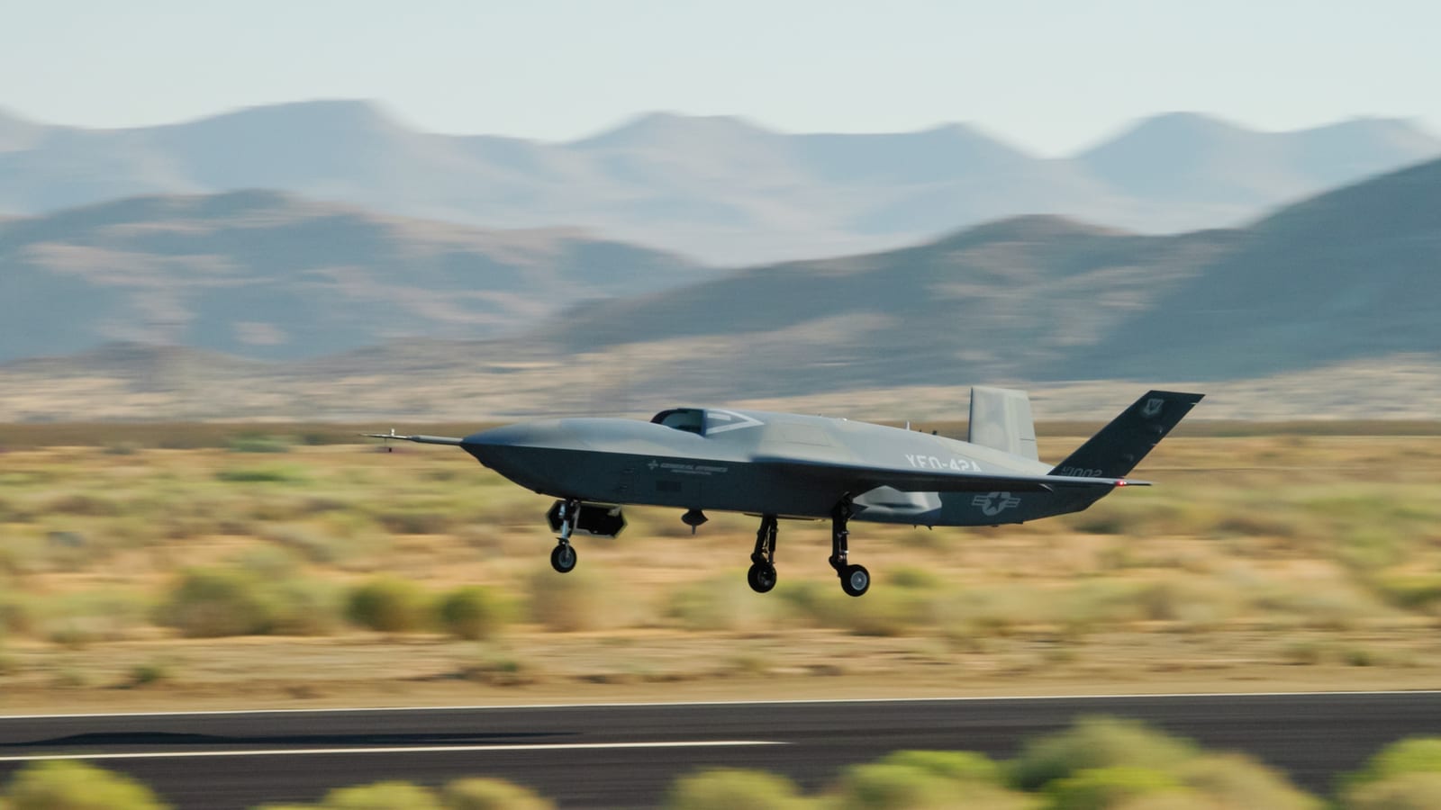 A YFQ-42A Collaborative Combat Aircraft drone, developed by General Atomics, takes off from a runway during flight testing at a California test location