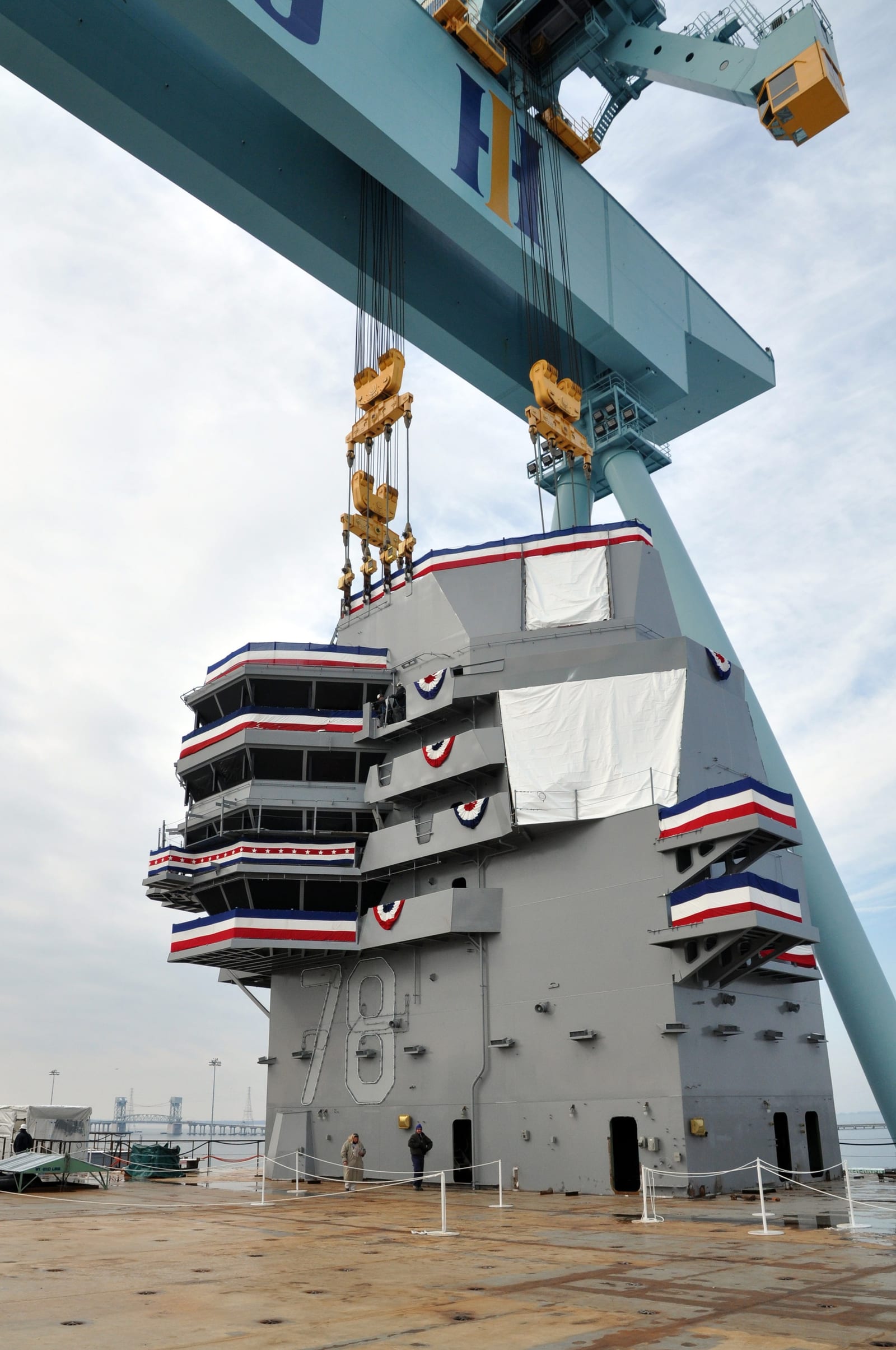 The 555-metric-ton island of Gerald R. Ford being lifted into position during construction at Newport News Shipbuilding