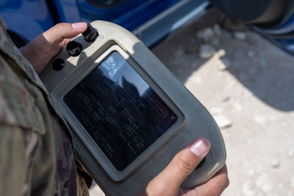 A U.S. Air Force airman with the 379th Expeditionary Security Forces Squadron pilots an RQ-20B Puma using a handheld control pad