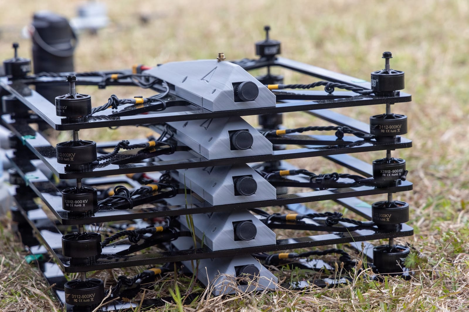 Small multi-rotor drones staged in a stacked test rig ahead of a swarm demonstration