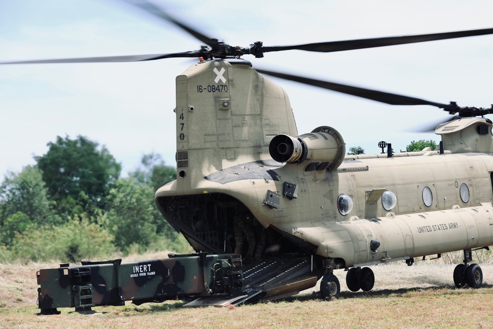 A CH-47 helicopter delivers PAC-3 MSE missile canisters to the 38th Air Defense Artillery Brigade during a resupply exercise