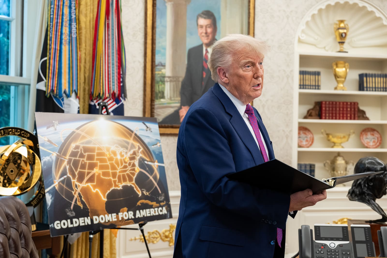 President Trump speaks with officials and staff in the Oval Office before his announcement of the Golden Dome missile defense system