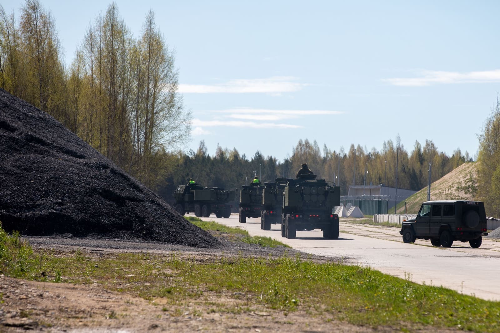 Estonian soldiers drive multiple M142 HIMARS launchers off the airfield at Amari Air Base, Estonia