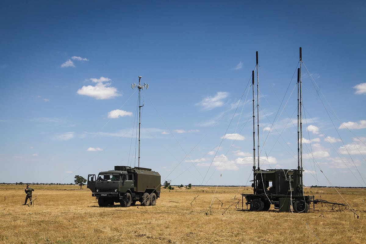 R-330Zh Zhitel, a Russian mobile electronic-warfare jamming vehicle with mast antennas deployed in an open field