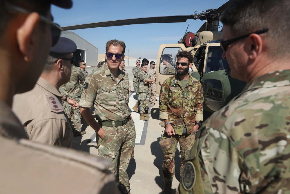 Coalition service members are welcomed by Royal Jordanian Air Force personnel at an aircraft open-house display in Jordan