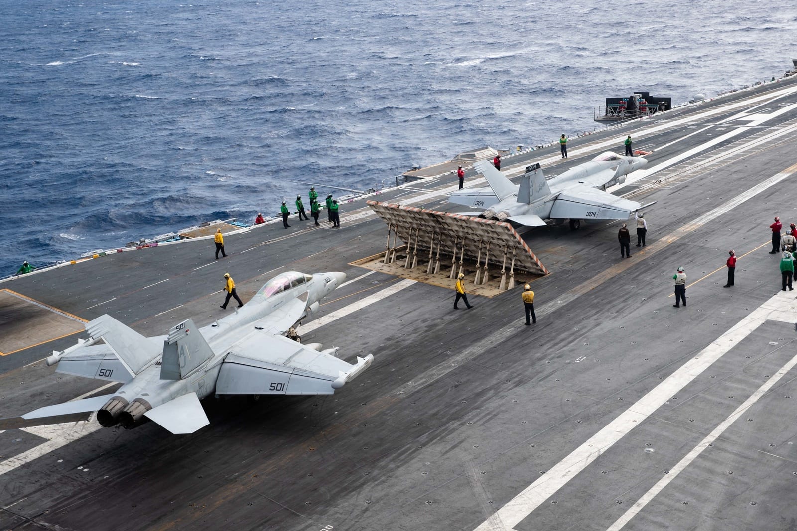 An E/A-18G Growler and F/A-18E Super Hornet prepare to launch from EMALS catapults on USS Gerald R. Ford's flight deck
