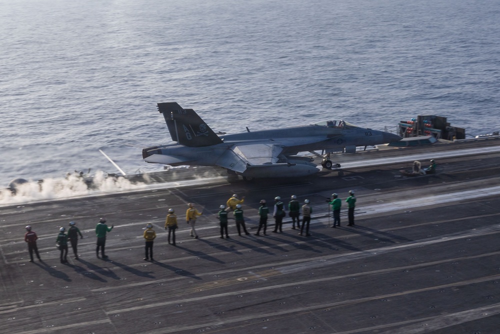 An F/A-18E Super Hornet launches from the flight deck of the aircraft carrier USS George H.W. Bush during flight operations