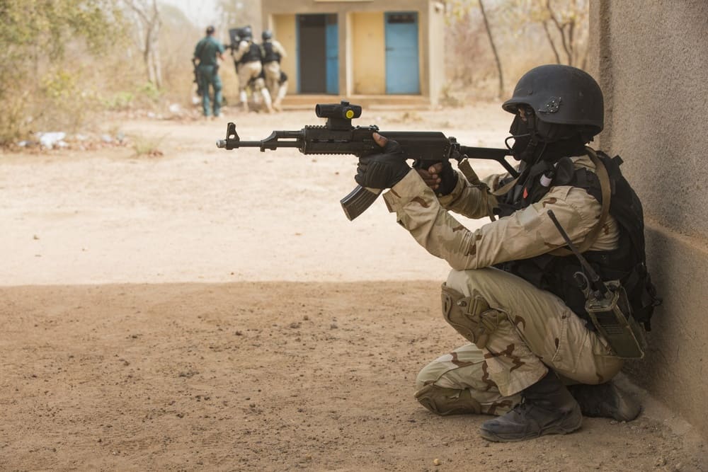 A Burkinabe soldier pulls security while his teammates clear an area during Exercise Flintlock 2019 near Po, Burkina Faso, three years before the 2022 coups that ended this kind of Western military partnership
