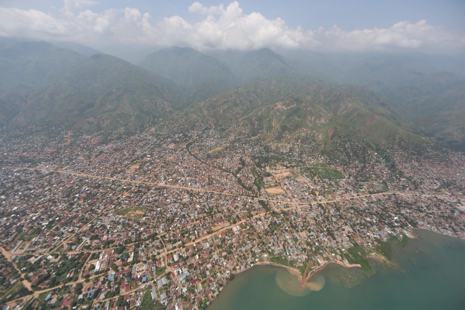 Aerial view of the town of Uvira on the shore of Lake Tanganyika, South Kivu, with dense housing between mountains and the lake