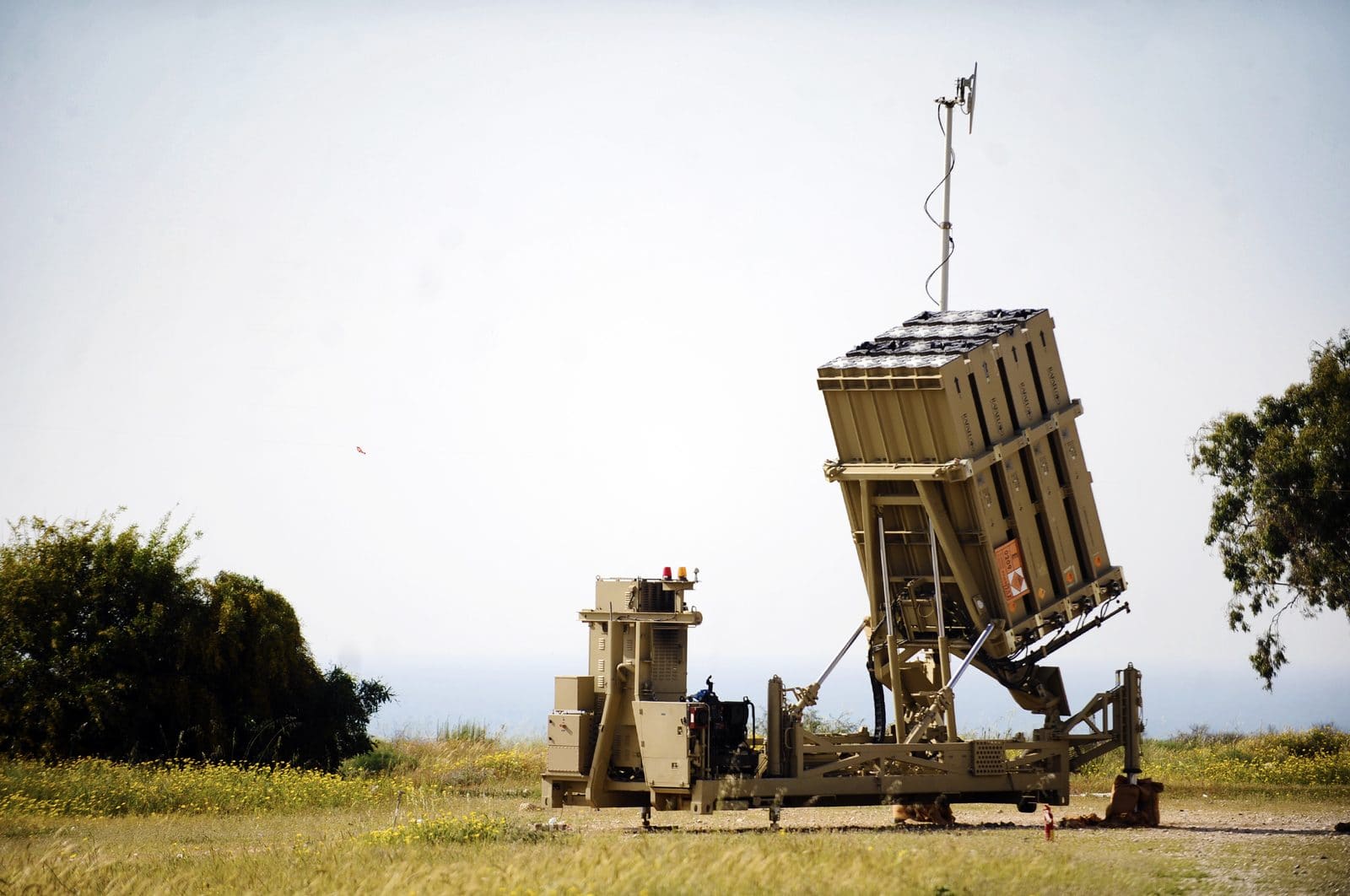 An Israeli Iron Dome air-defense battery, mounted launchers visible, deployed near Ashkelon