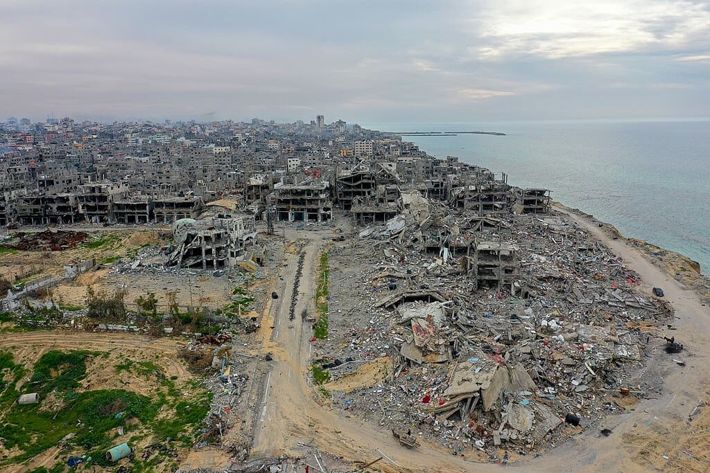 Aerial view of widespread destroyed and damaged multi-story buildings in the Beach refugee camp in Gaza City