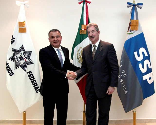 Genaro García Luna, then Mexico's secretary of public security, shaking hands with a US Justice Department official in Mexico City