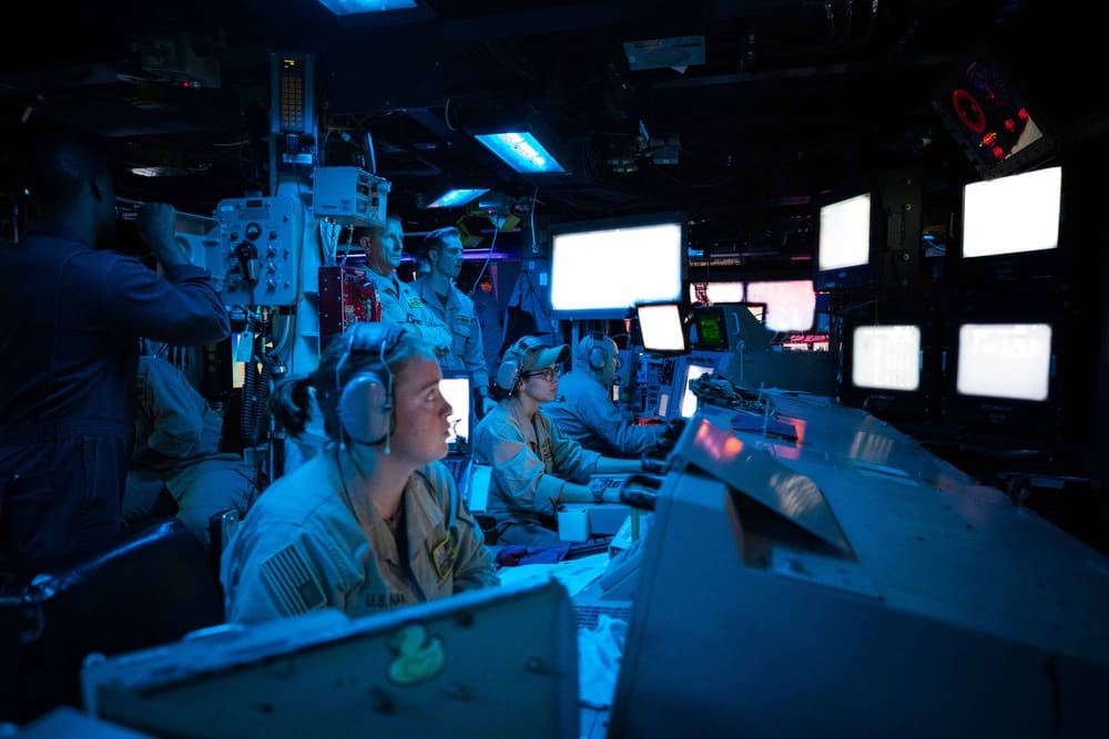 Sailors aboard the destroyer USS Carney in the ship's Combat Information Center during its engagement of Houthi missiles and drones in the Red Sea, October 19, 2023