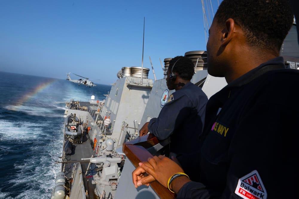 Sailors aboard the destroyer USS Mason observe an MH-60S Seahawk helicopter while the ship operates in the Red Sea in support of Operation Prosperity Guardian, December 22, 2023