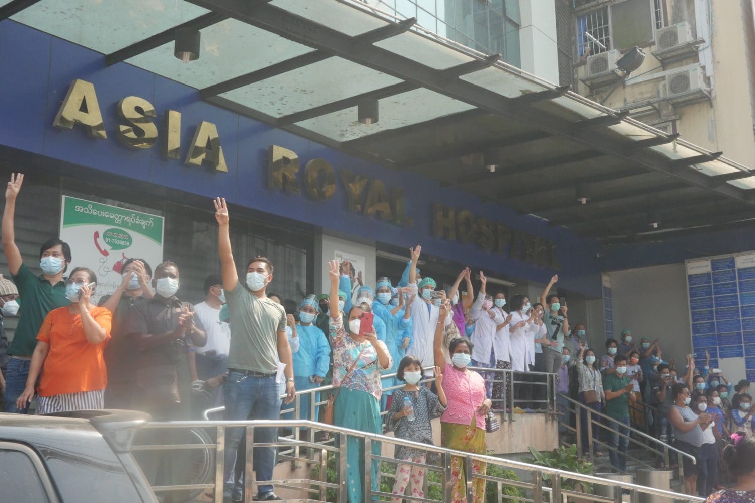 Medical staff giving the three-finger salute in protest at a private hospital in Yangon during the Civil Disobedience Movement