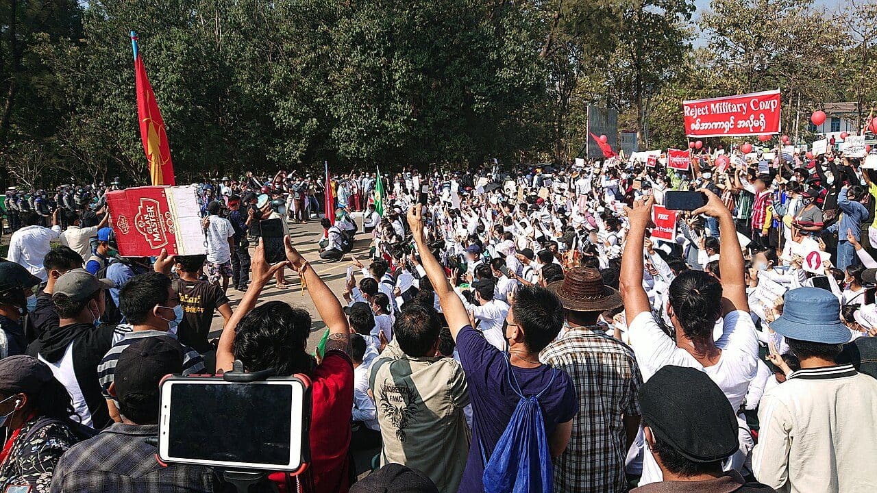 Student union members and teachers holding signs and marching in a street protest against Myanmar's military coup in Hpa-An, Kayin State, February 2021