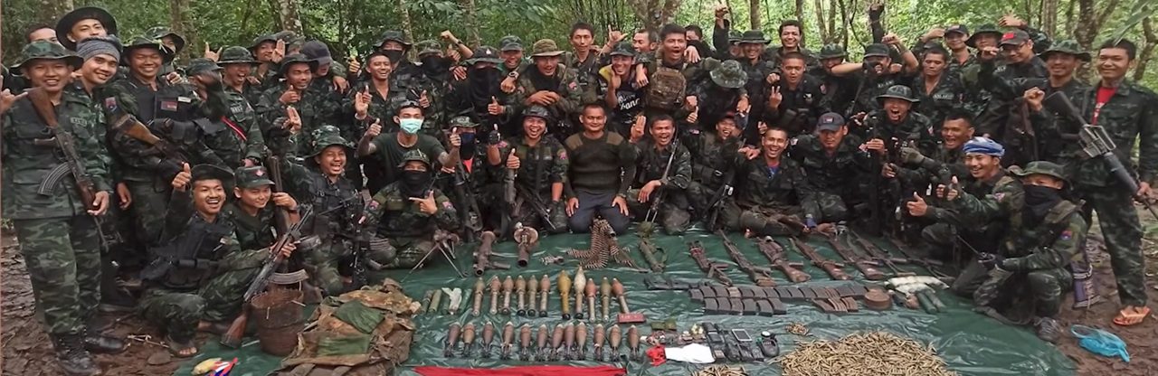 Karen National Liberation Army fighters posing with captured equipment at a Tatmadaw camp in Kawkareik Township