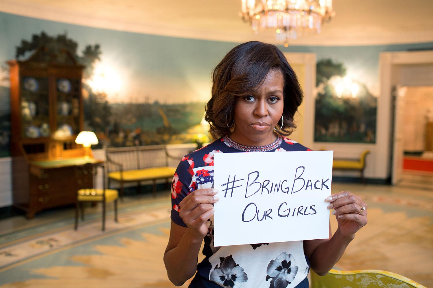 US First Lady Michelle Obama holds a sign reading #BringBackOurGirls, May 2014