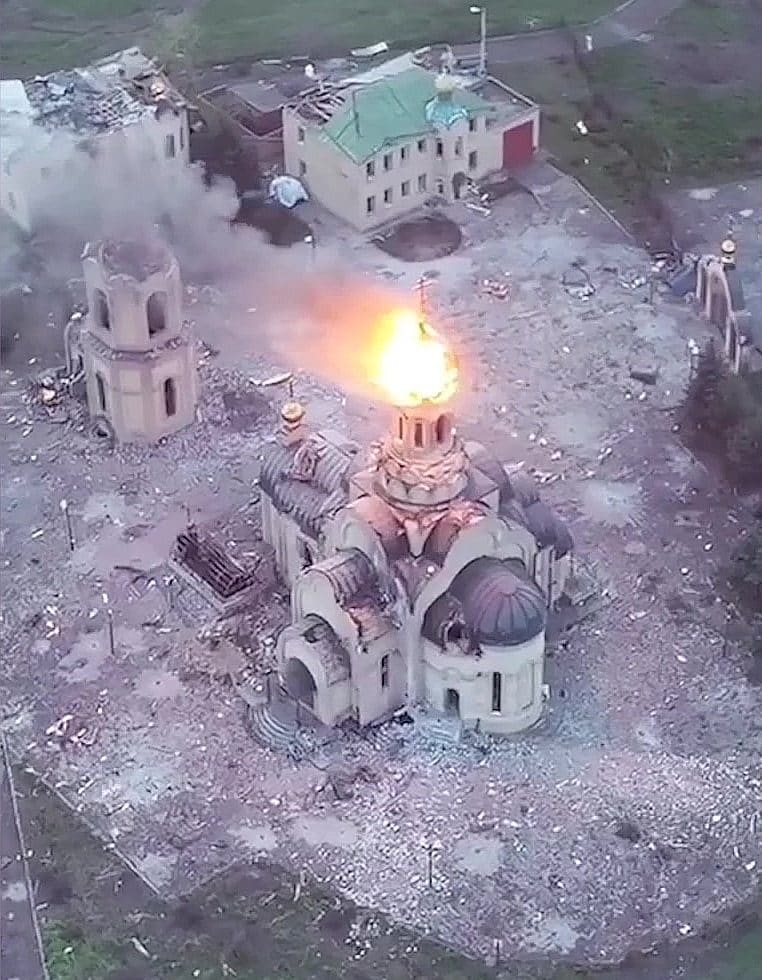 The Annunciation church in western Bakhmut engulfed in fire amid the ruins of the city in May 2023, around the time Wagner claimed its capture