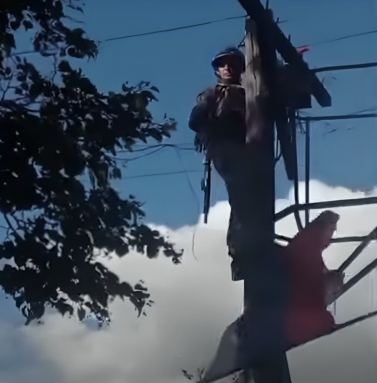 A Ukrainian soldier removing a Russian flag from a pole in Apanasovka, Kursk Oblast, during Ukraine's cross-border offensive