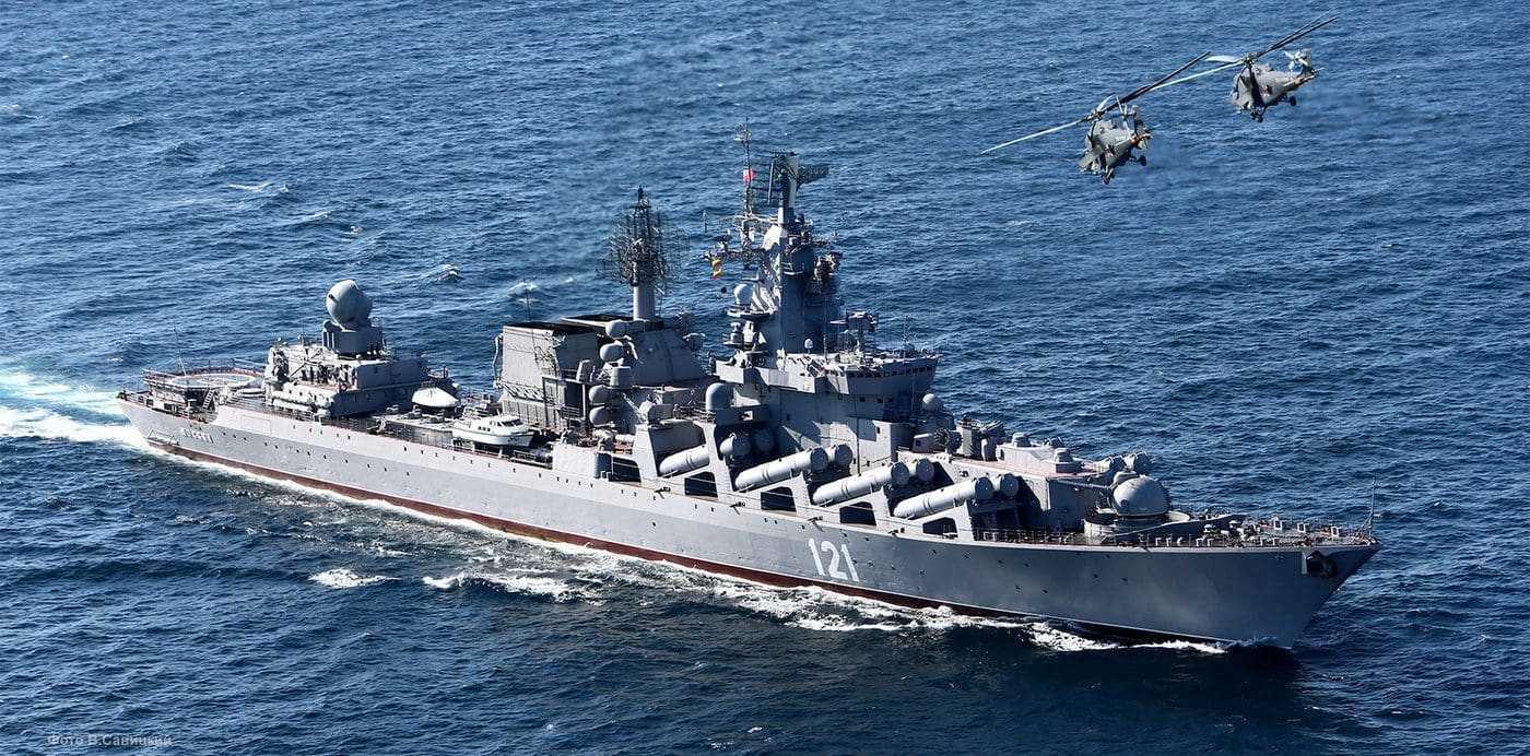 The Russian Black Sea Fleet cruiser Moskva underway at sea with two naval helicopters flying overhead