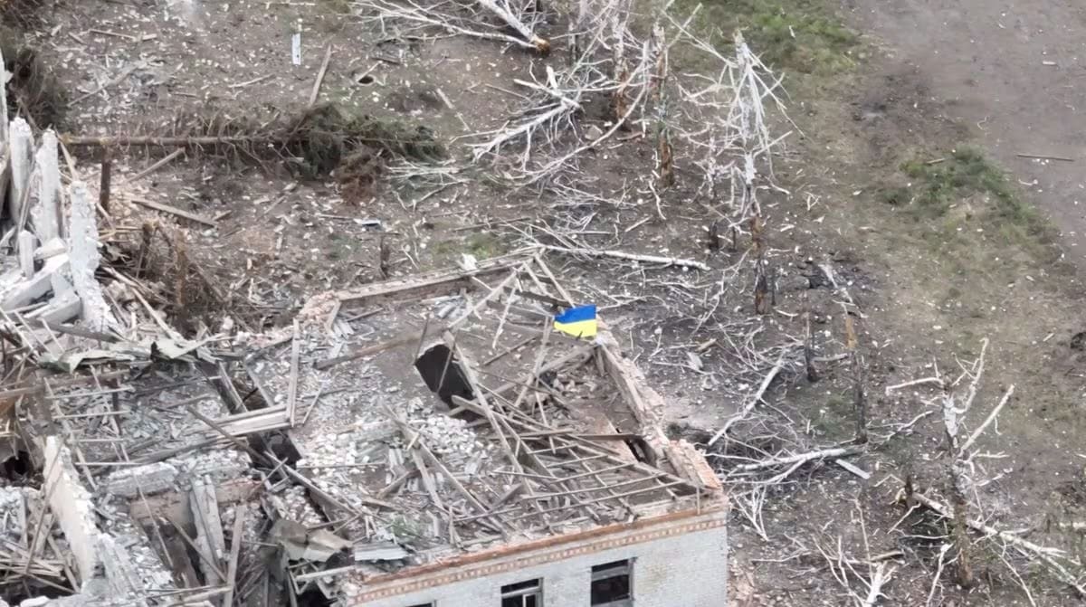 Aerial view of a small Ukrainian flag planted atop a destroyed building in Robotyne after Ukrainian forces recaptured the village
