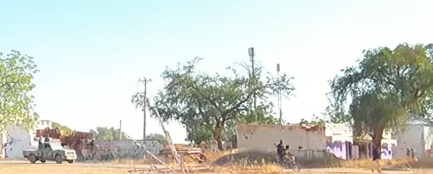 Rapid Support Forces vehicles and fighters moving through El Fasher, Sudan, after the city's fall