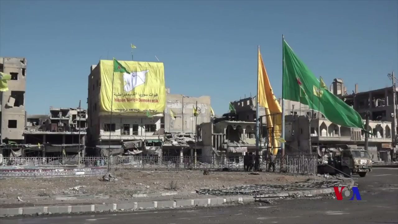 Flags of the Syrian Democratic Forces, YPG and YPJ displayed in central Raqqa after the city's capture