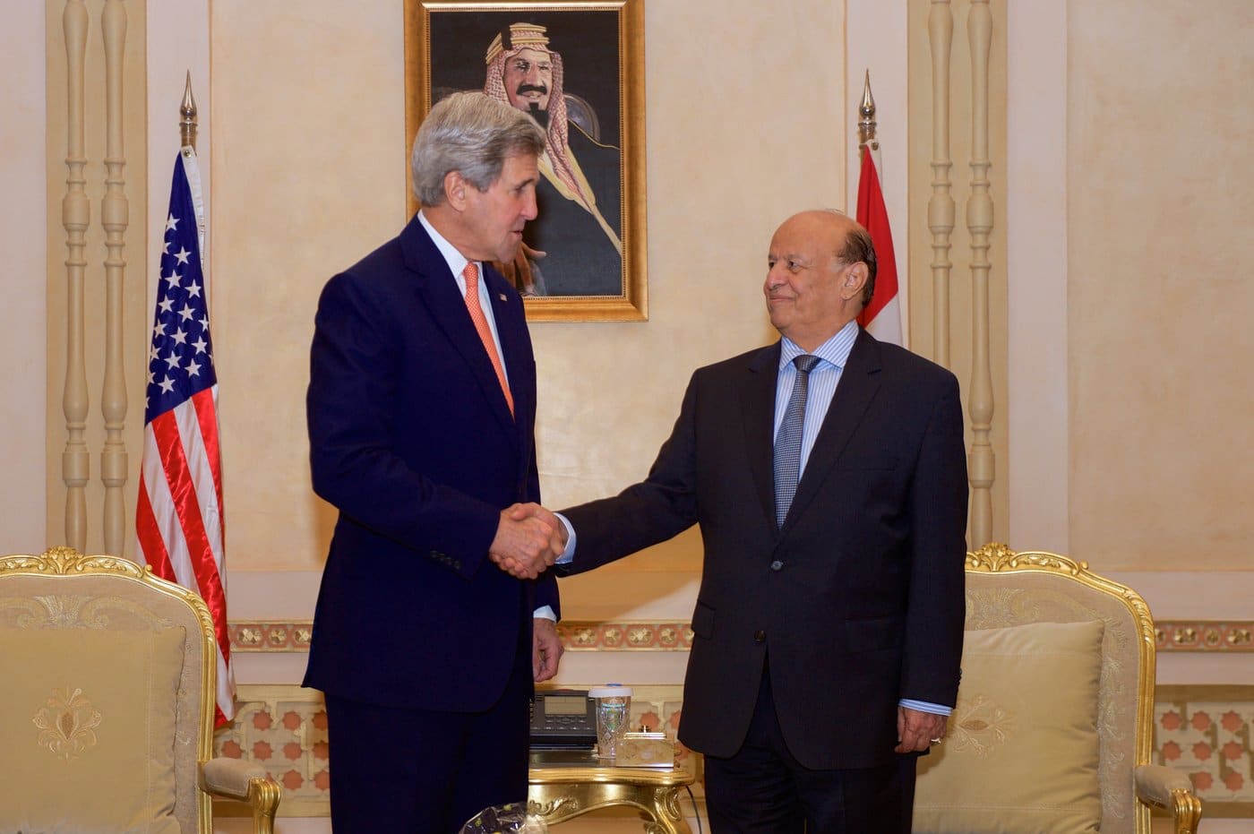 Yemeni President Abdrabbuh Mansur Hadi shakes hands with U.S. Secretary of State John Kerry in Riyadh, Saudi Arabia, where Hadi's government relocated after he fled Yemen